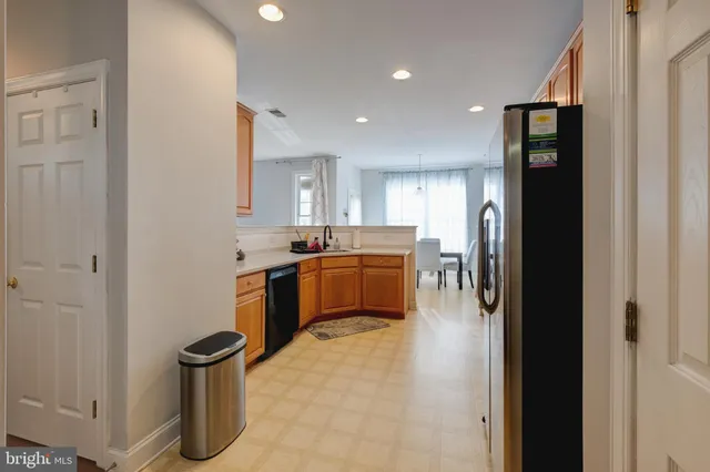 a kitchen with a refrigerator and a sink