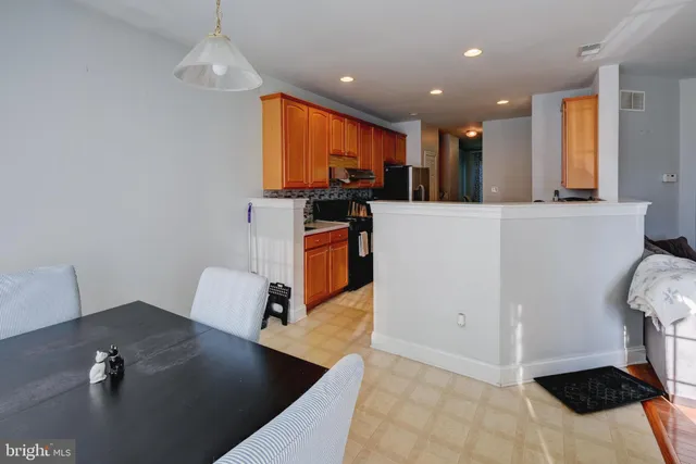 a kitchen with stainless steel appliances granite countertop a sink a stove and a refrigerator