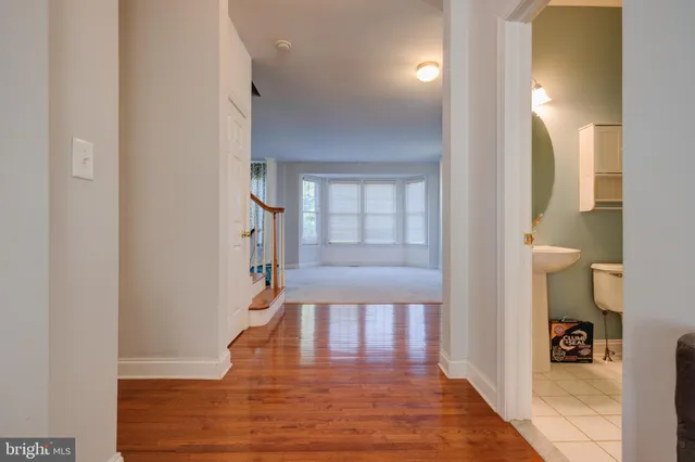 a view of a hallway view with wooden floor and staircase