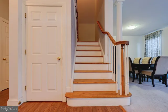 a view of entryway with wooden floor and dining room