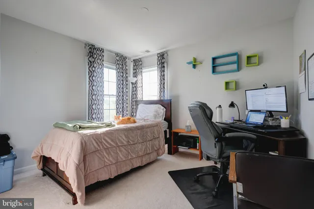 a bedroom with a bed and a desk