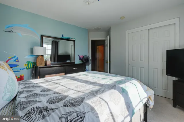 a bed room with a bed a television and a mirror