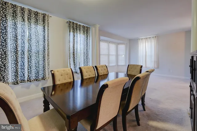 a view of a dining room with furniture and window