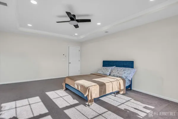 a bedroom with a bed and a ceiling fan
