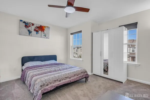 a bedroom with a bed and a painting on the wall