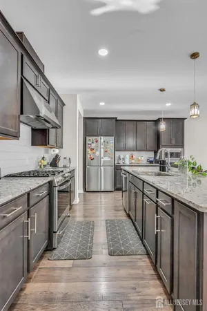 a large kitchen with stainless steel appliances lots of counter space and a sink