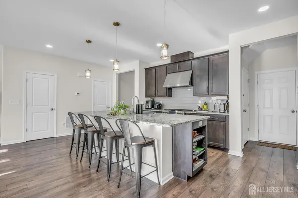 a kitchen with a table chairs refrigerator and cabinets