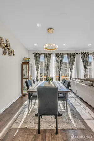 a dining room with furniture and a large window