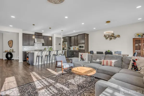 a living room with furniture and kitchen view