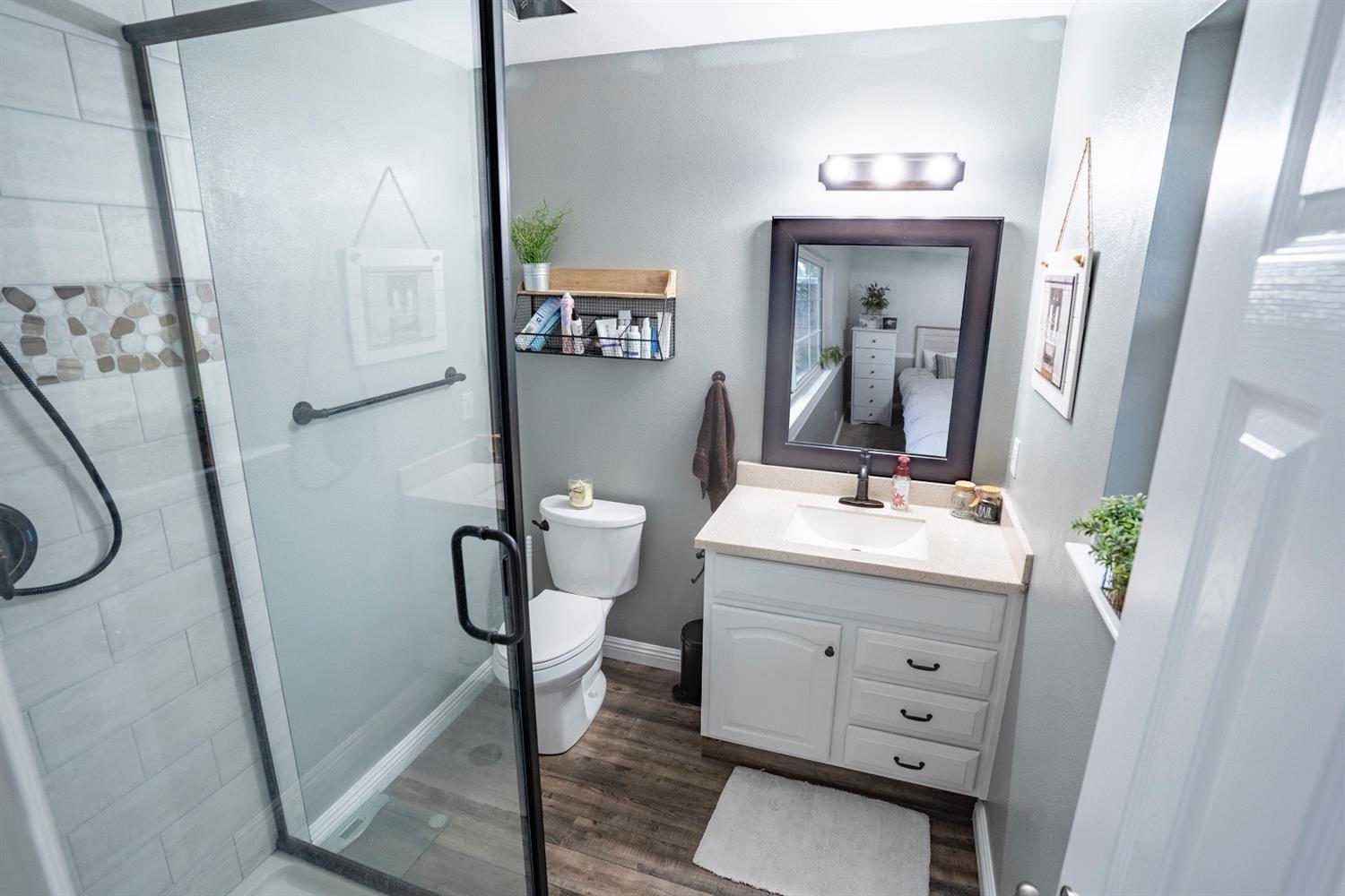 1607 Ashlan Avenue Clovis, CA 93611 - Photo 14 of 17 a bathroom with a sink a toilet and mirror