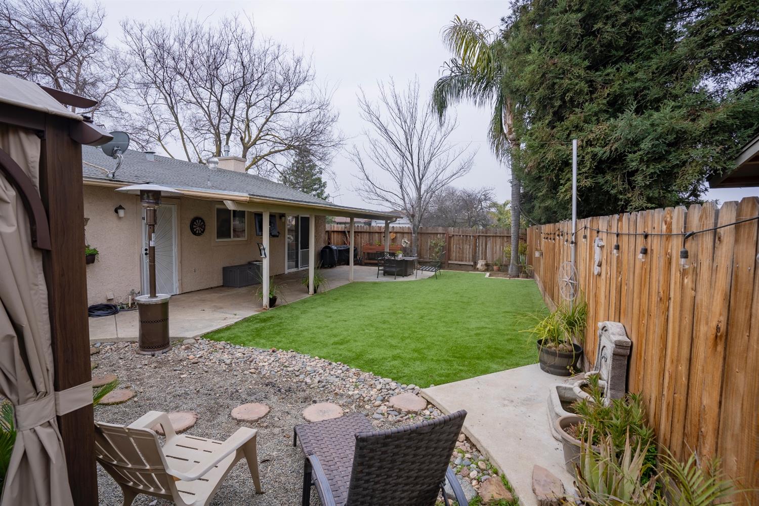 1607 Ashlan Avenue Clovis, CA 93611 - Photo 16 of 17 a view of a house with backyard and a tree