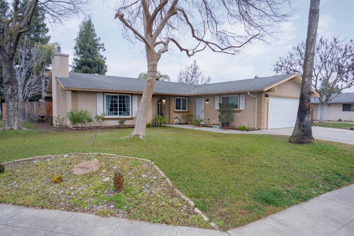 1607 Ashlan Avenue Clovis, CA 93611 - Photo 2 of 17 a front view of a house with garden