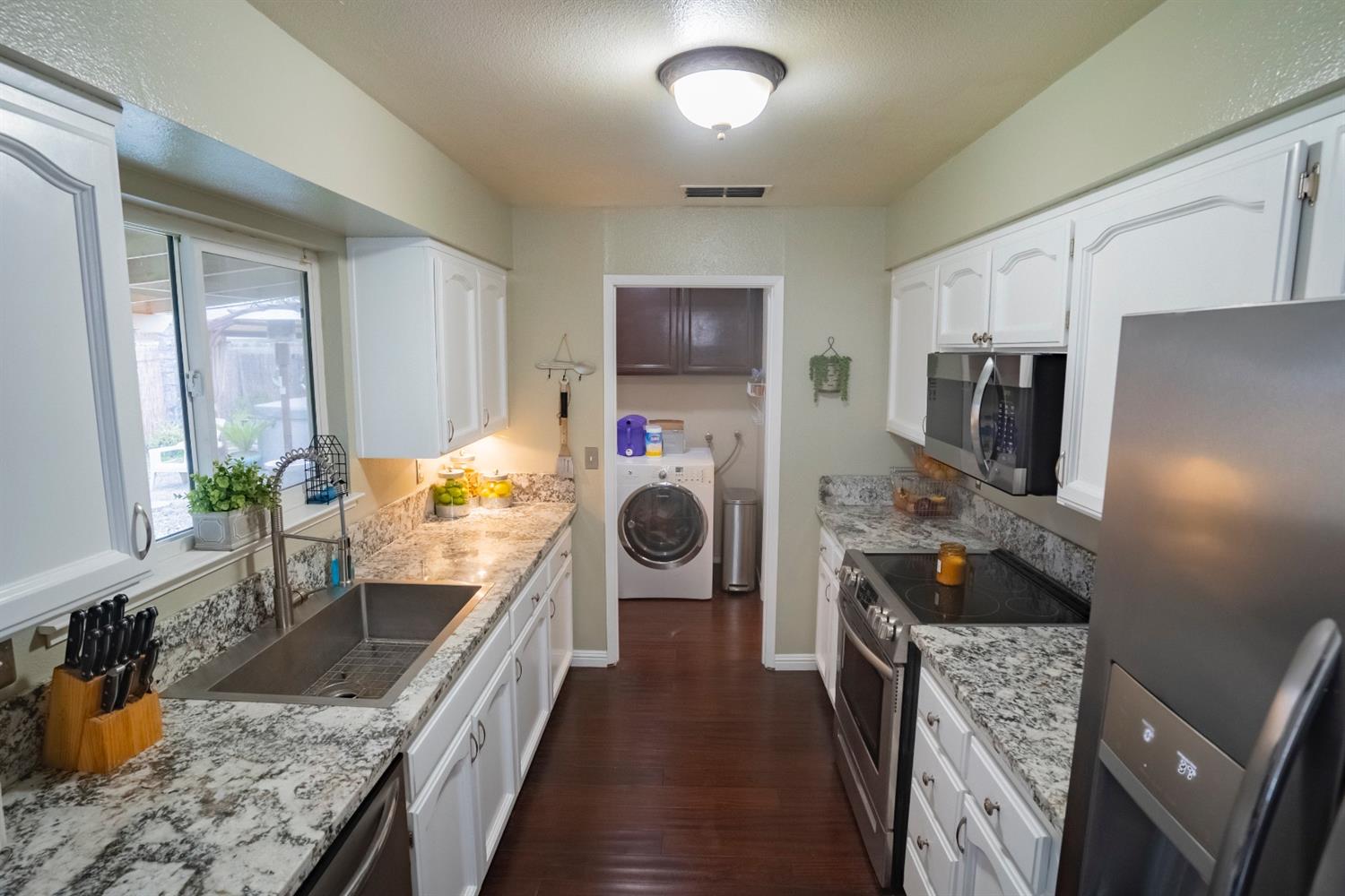 1607 Ashlan Avenue Clovis, CA 93611 - Photo 4 of 17 a kitchen with stainless steel appliances granite countertop a refrigerator and a stove