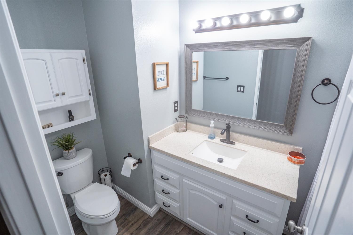 1607 Ashlan Avenue Clovis, CA 93611 - Photo 9 of 17 a bathroom with a toilet a sink and mirror