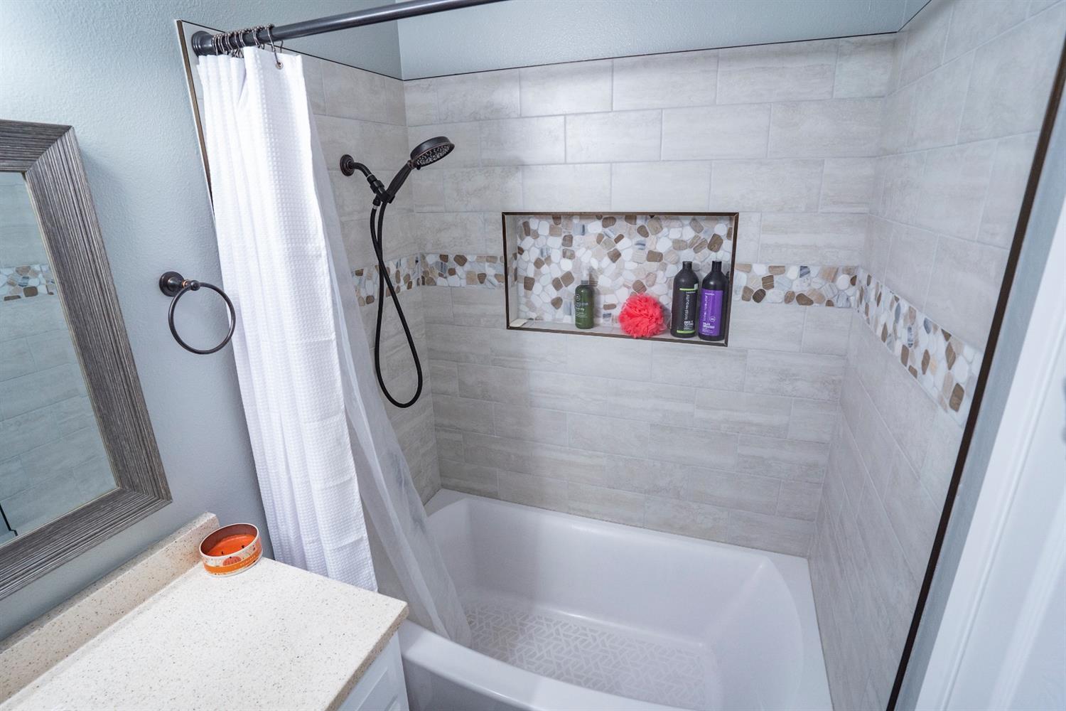 1607 Ashlan Avenue Clovis, CA 93611 - Photo 10 of 17 a bathroom with a bathtub and shower