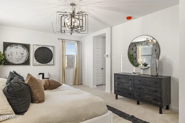 a bedroom with a bed and a dresser