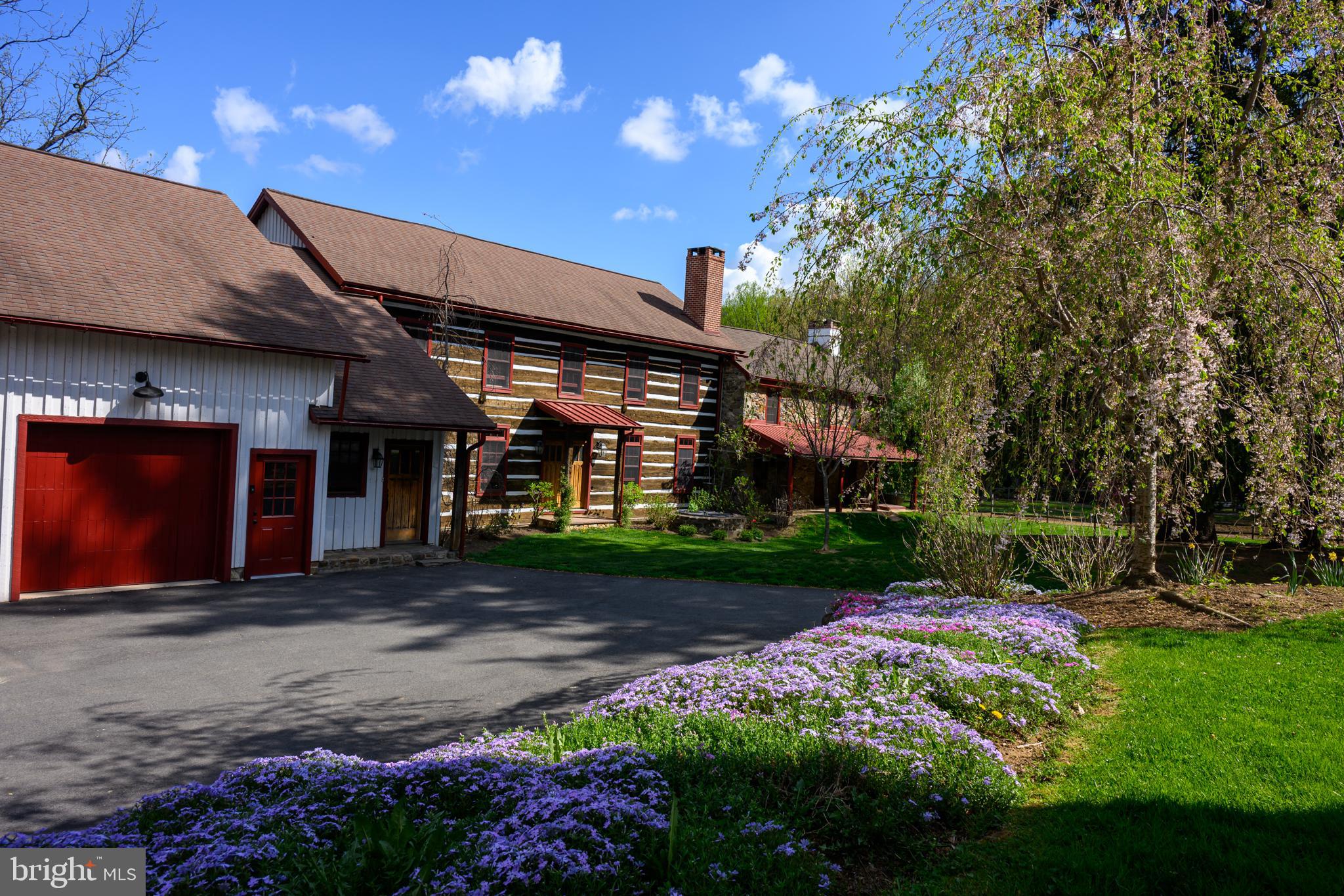 a view of a house with a yard and garden