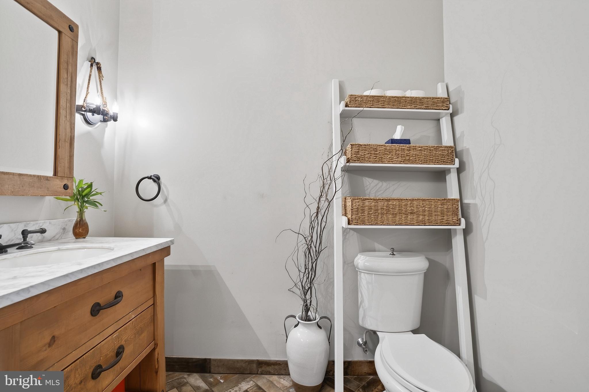 201 Pine Swamp Road Elverson, PA 19520 - Photo 20 of 60 a bathroom with a toilet a sink and mirror