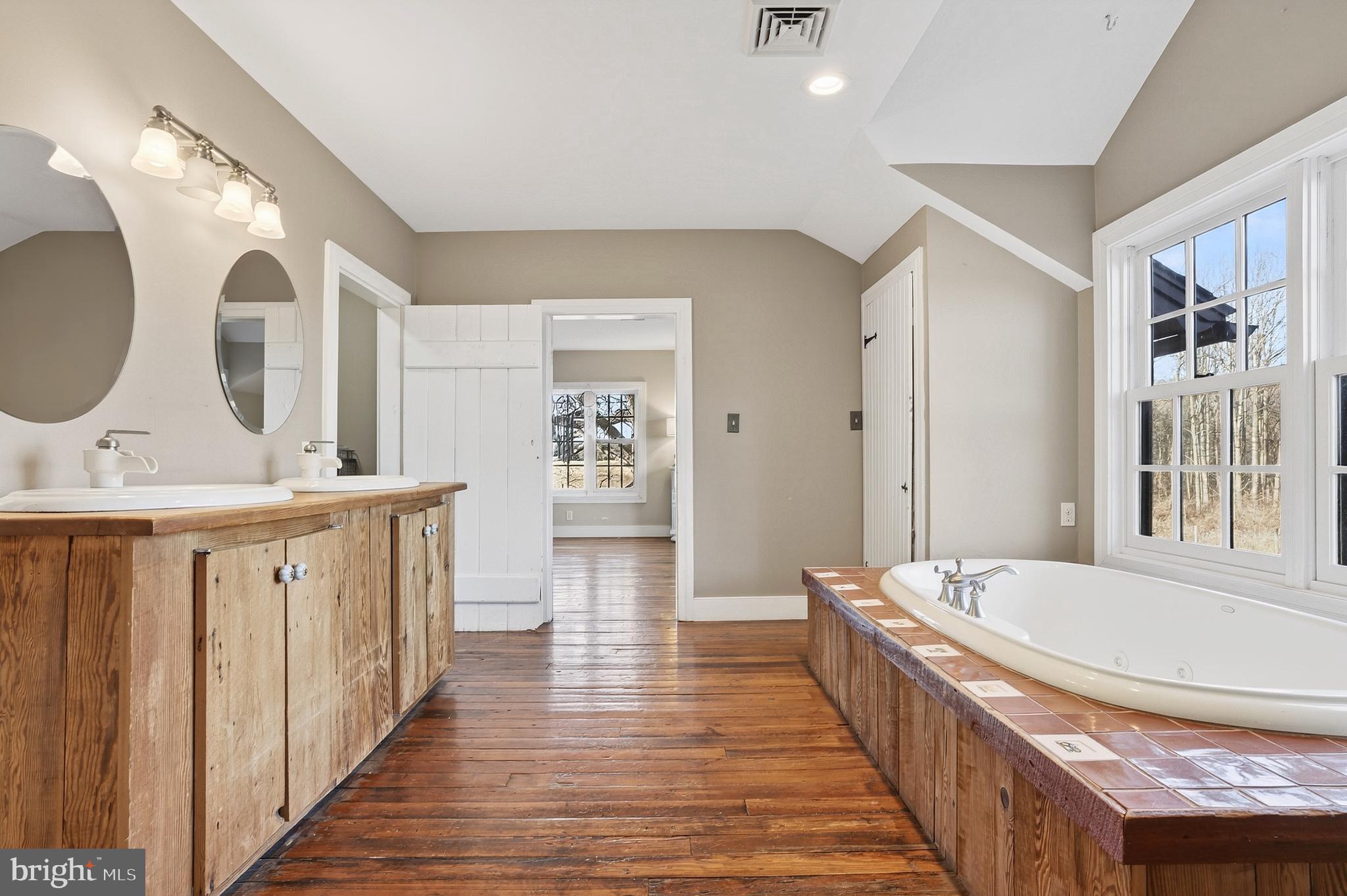201 Pine Swamp Road Elverson, PA 19520 - Photo 26 of 60 a bathroom with a double vanity sink and a mirror