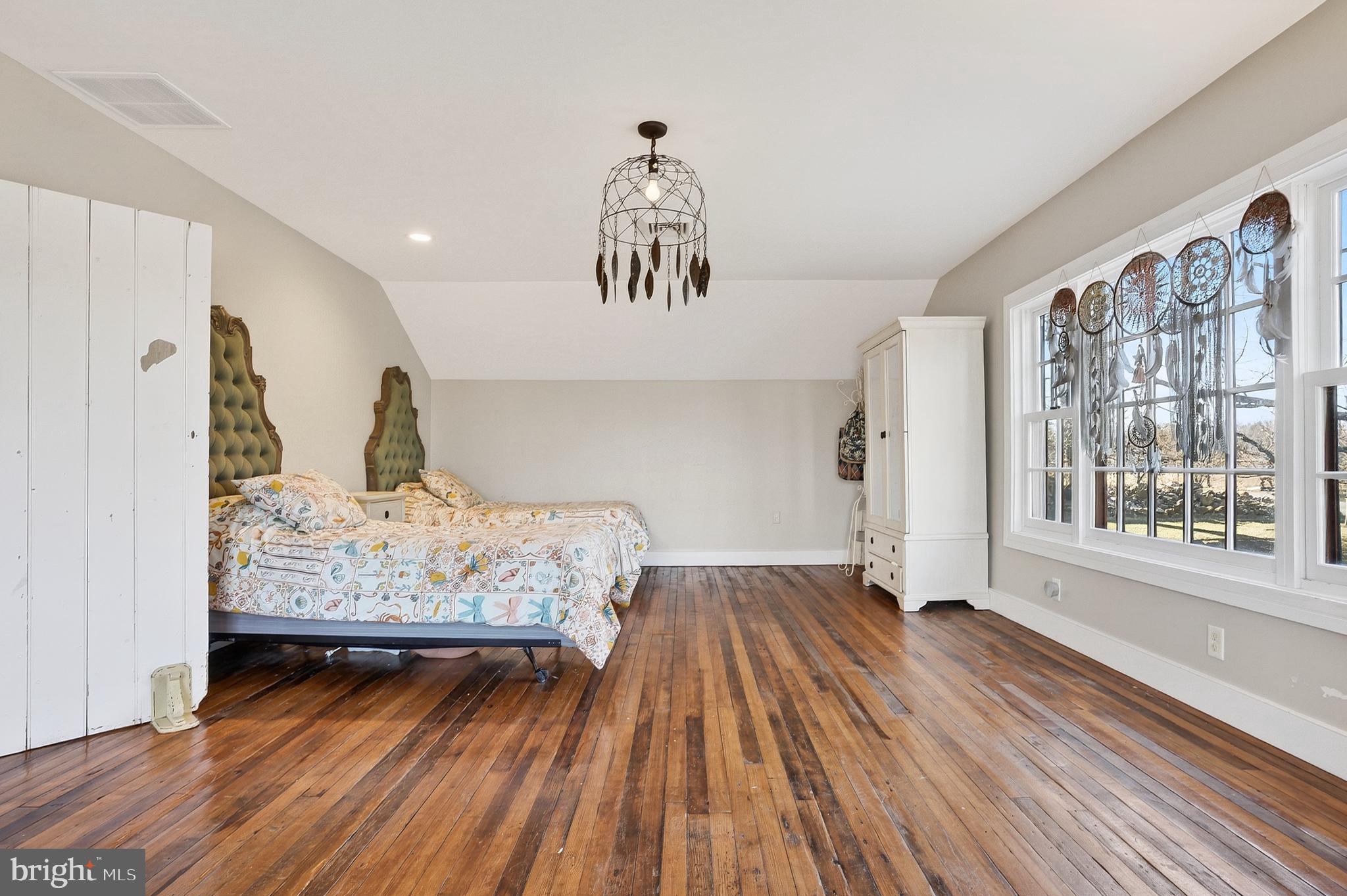 201 Pine Swamp Road Elverson, PA 19520 - Photo 28 of 60 a bedroom with a bed and wooden floor