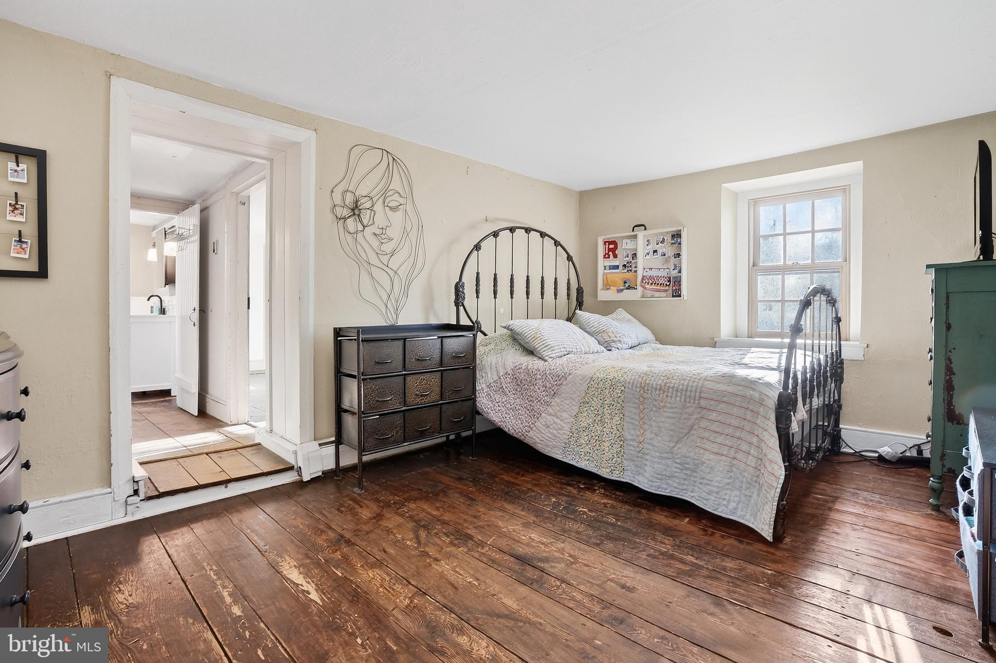 201 Pine Swamp Road Elverson, PA 19520 - Photo 34 of 60 a bedroom with a bed and a chandelier