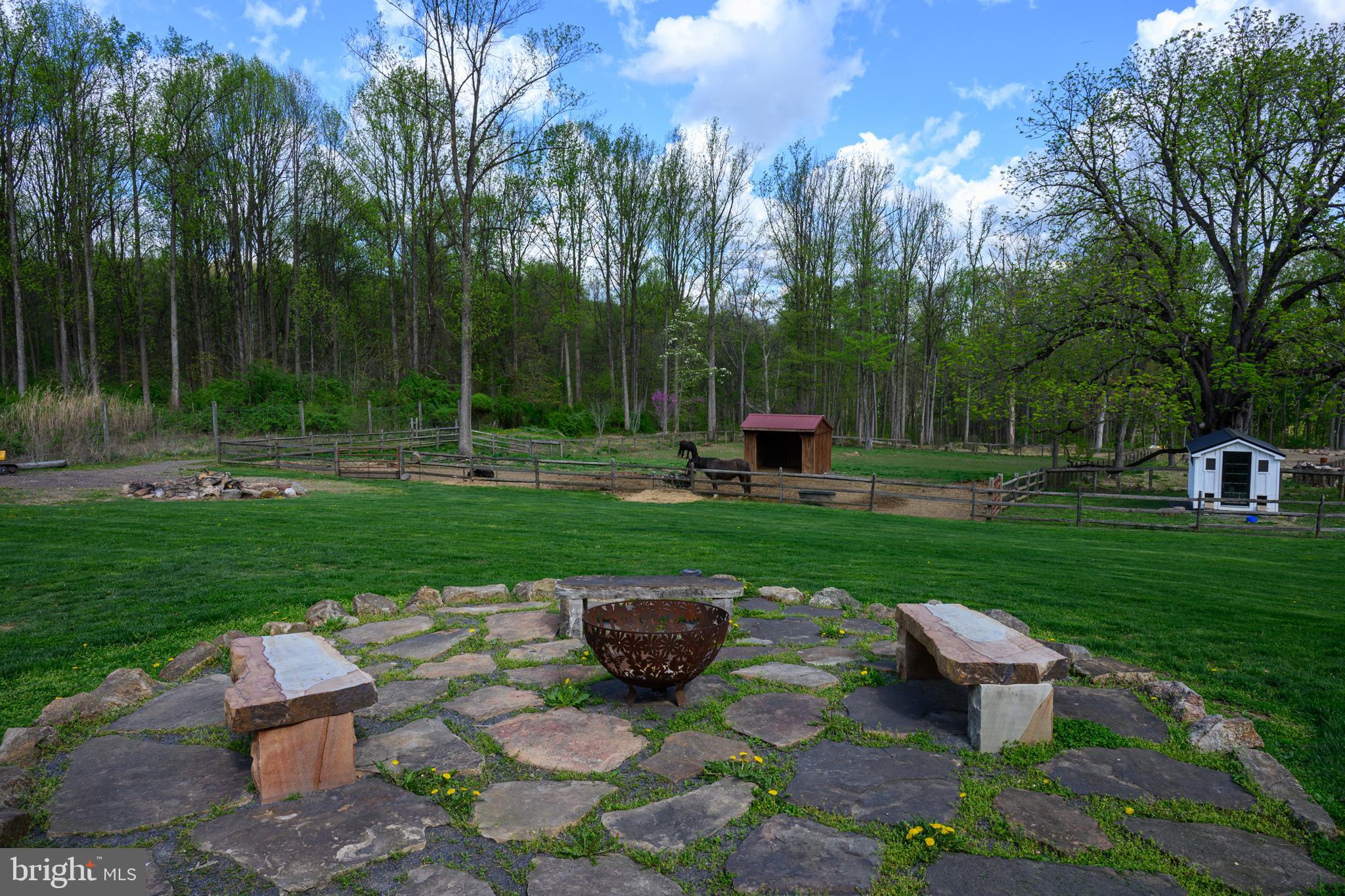 201 Pine Swamp Road Elverson, PA 19520 - Photo 43 of 60 a view of a table and chairs in the garden
