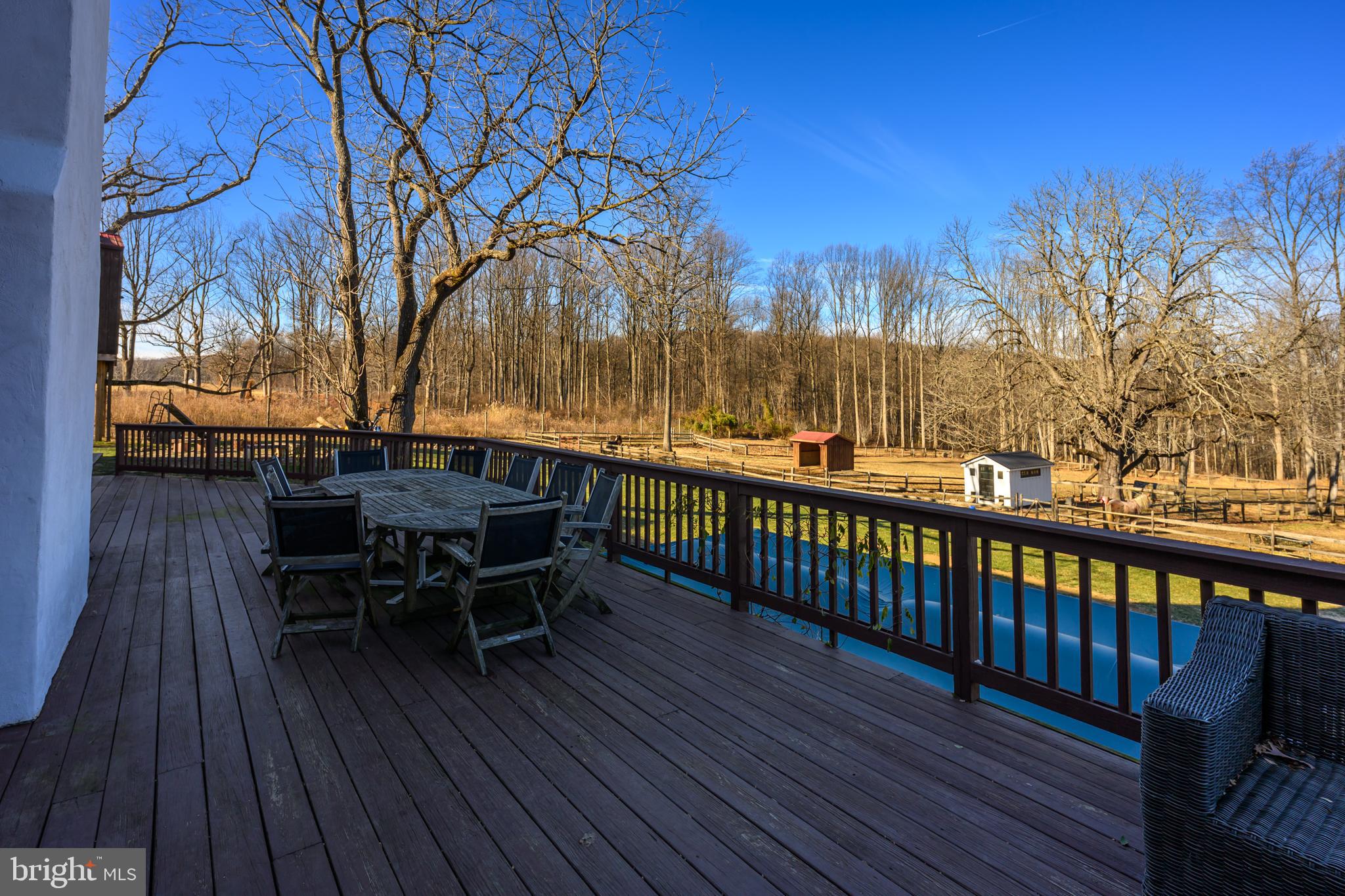 201 Pine Swamp Road Elverson, PA 19520 - Photo 46 of 60 a view of a roof deck with table and chairs and wooden floor