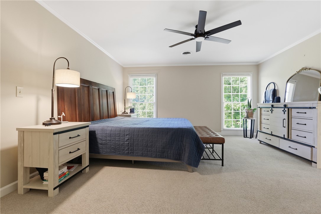 103 5 Knoll Court Anderson, SC 29621 - Photo 13 of 33 The tranquil bedroom offers ample space, crown molding, and soft, neutral carpet underfoot.