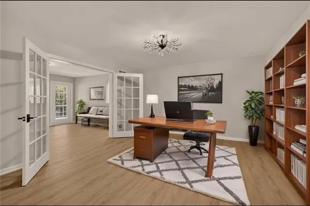 a living room with furniture a piano and a bookshelf