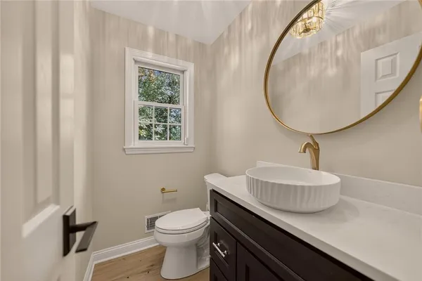a bathroom with a sink a mirror and a toilet