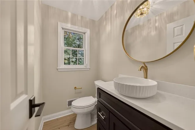 a bathroom with a sink a mirror and a toilet
