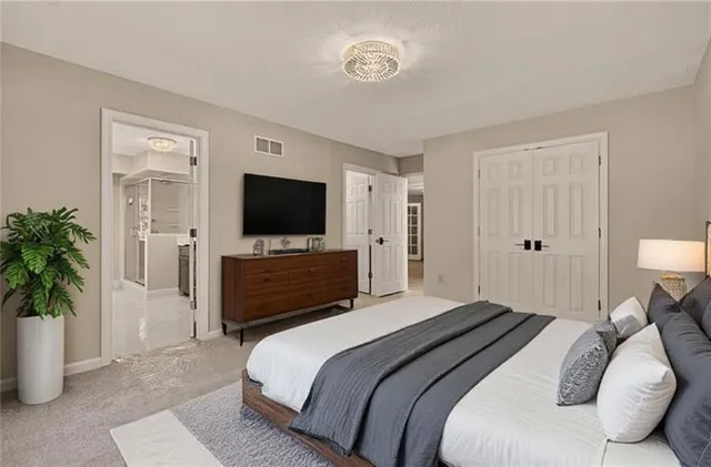 a bedroom with a bed and a flat screen tv