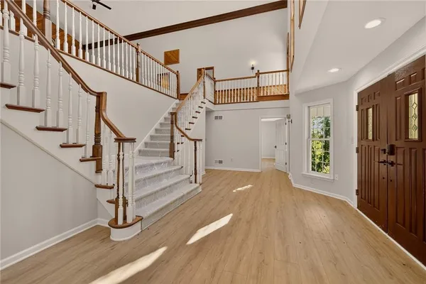 a view of entryway with wooden floor and stairs