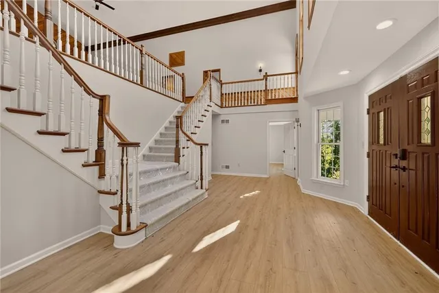 a view of entryway with wooden floor and stairs
