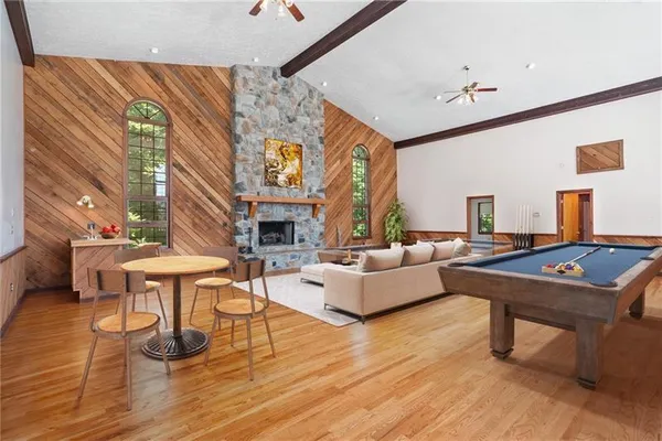 a living room with fireplace furniture and a large window