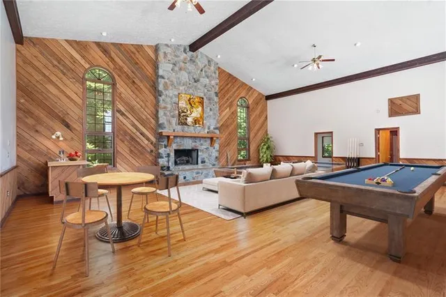 a living room with fireplace furniture and a large window