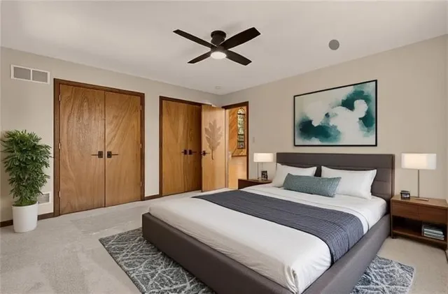 a bedroom with a large bed and a chandelier