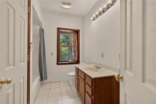 a bathroom with a sink vanity and a mirror