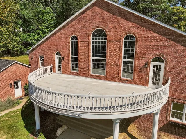 a view of a house with a wooden deck