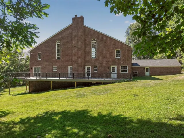 a house view with swimming pool in front of it
