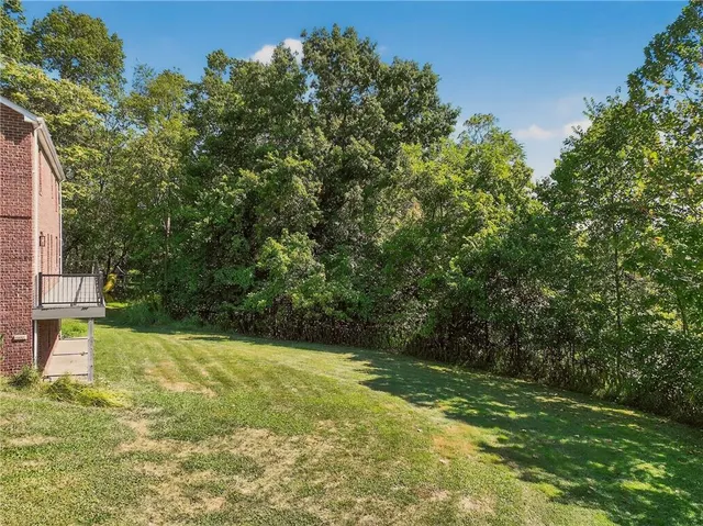 a view of yard with swimming pool and green space