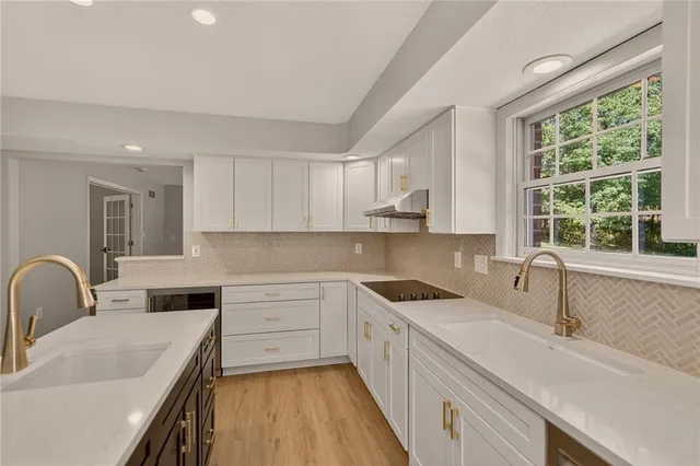 a kitchen with a sink stove and cabinets