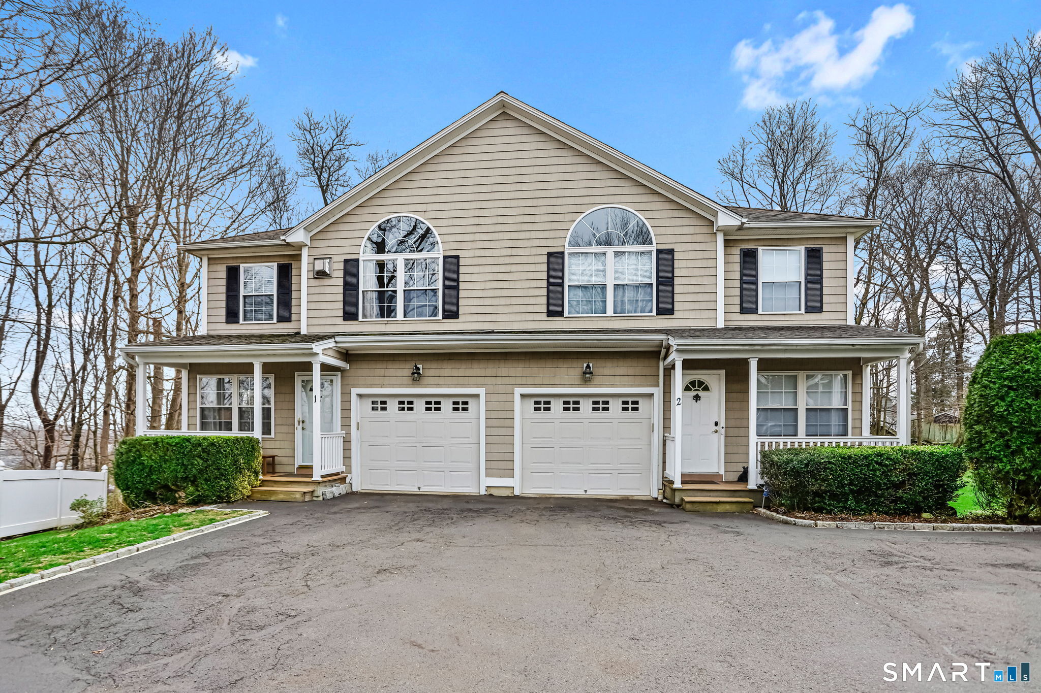 56 Soundview Avenue, Unit 1 Norwalk, CT 06854 - Photo 1 of 1 a view of a white house with large windows and a large tree