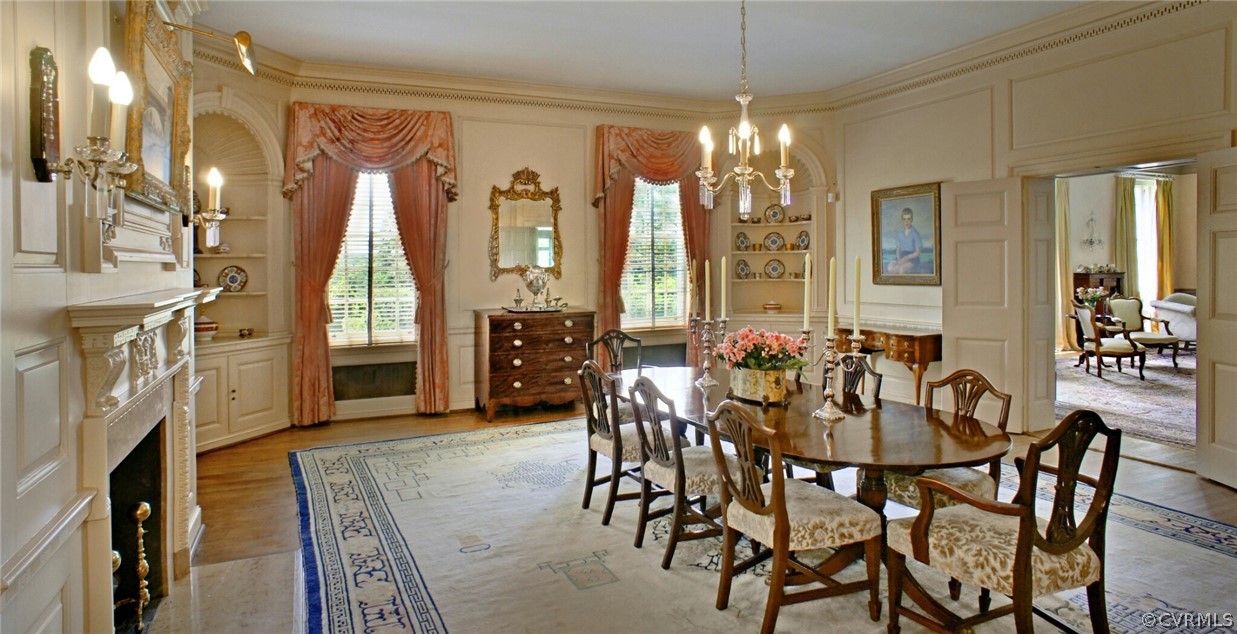 8899 River Road Henrico, VA 23229 - Photo 11 of 50 a view of a dining room with furniture and a chandelier