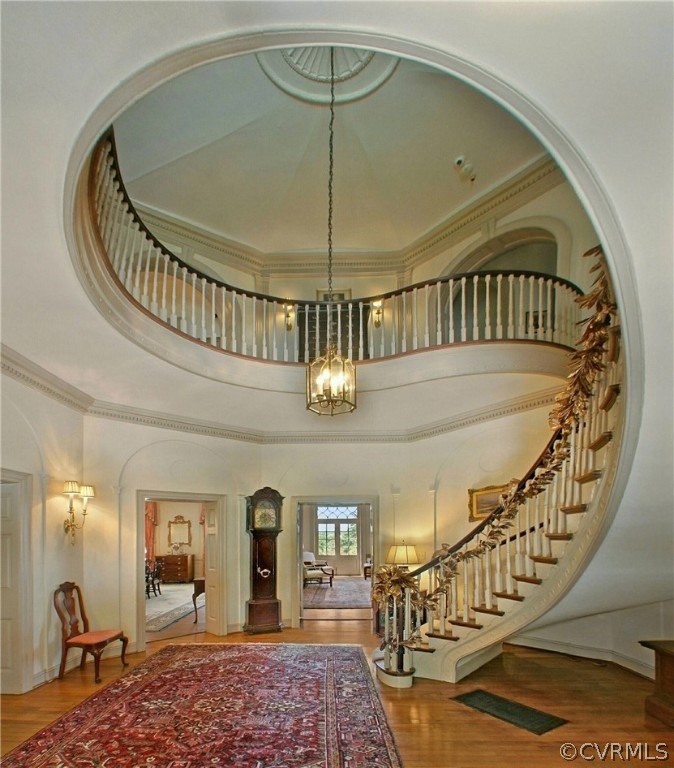 8899 River Road Henrico, VA 23229 - Photo 14 of 50 a view of staircase with a chandelier