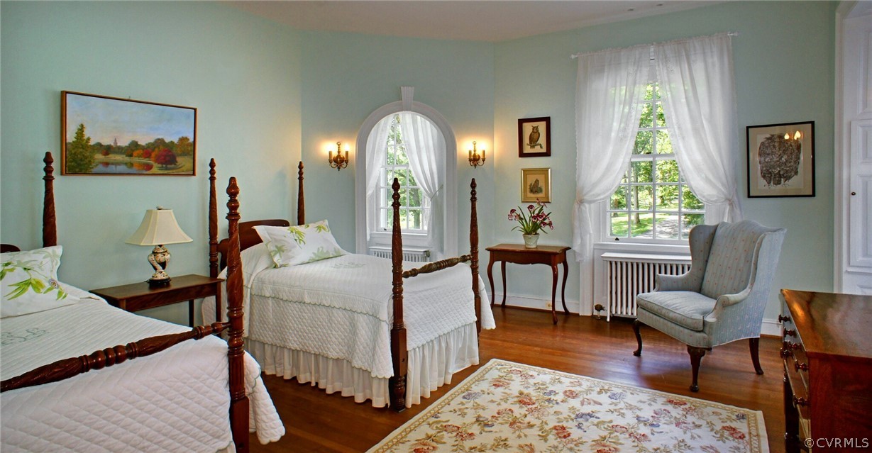 8899 River Road Henrico, VA 23229 - Photo 26 of 50 a bedroom with a bed and wooden floor