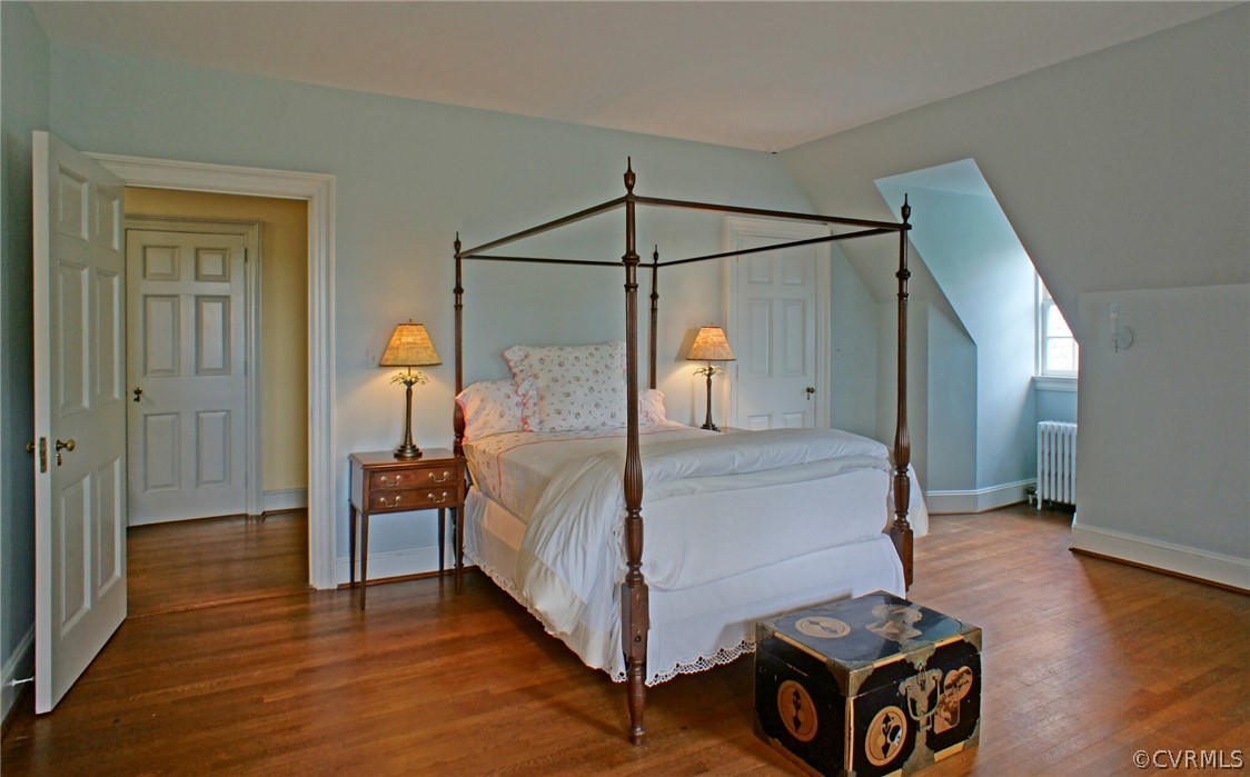 8899 River Road Henrico, VA 23229 - Photo 27 of 50 a bedroom with a bed and wooden floor