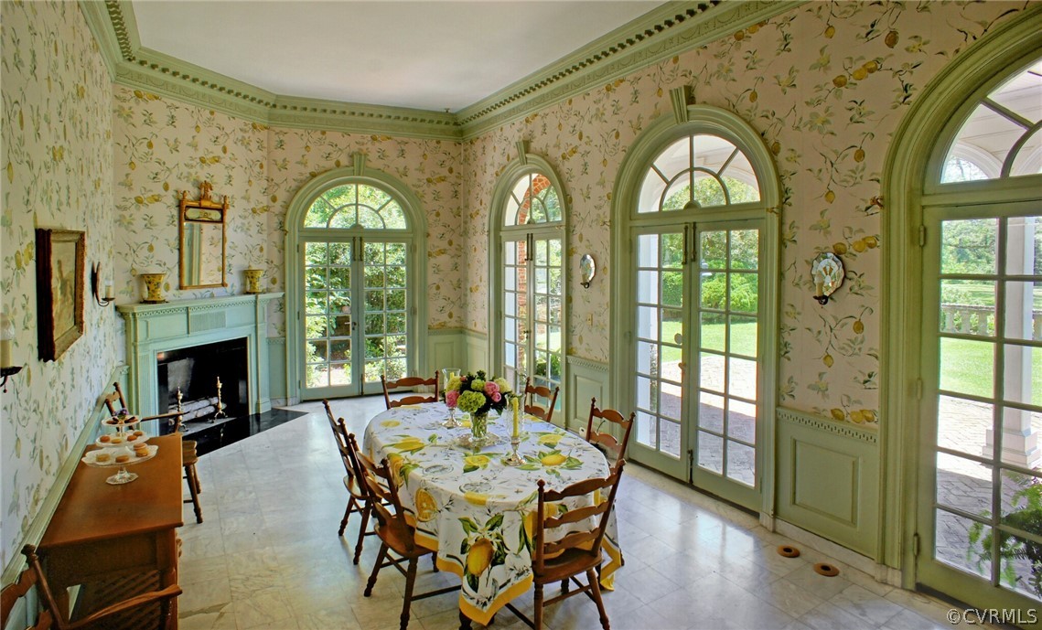 8899 River Road Henrico, VA 23229 - Photo 28 of 50 a dining room with fireplace windows and wooden floor