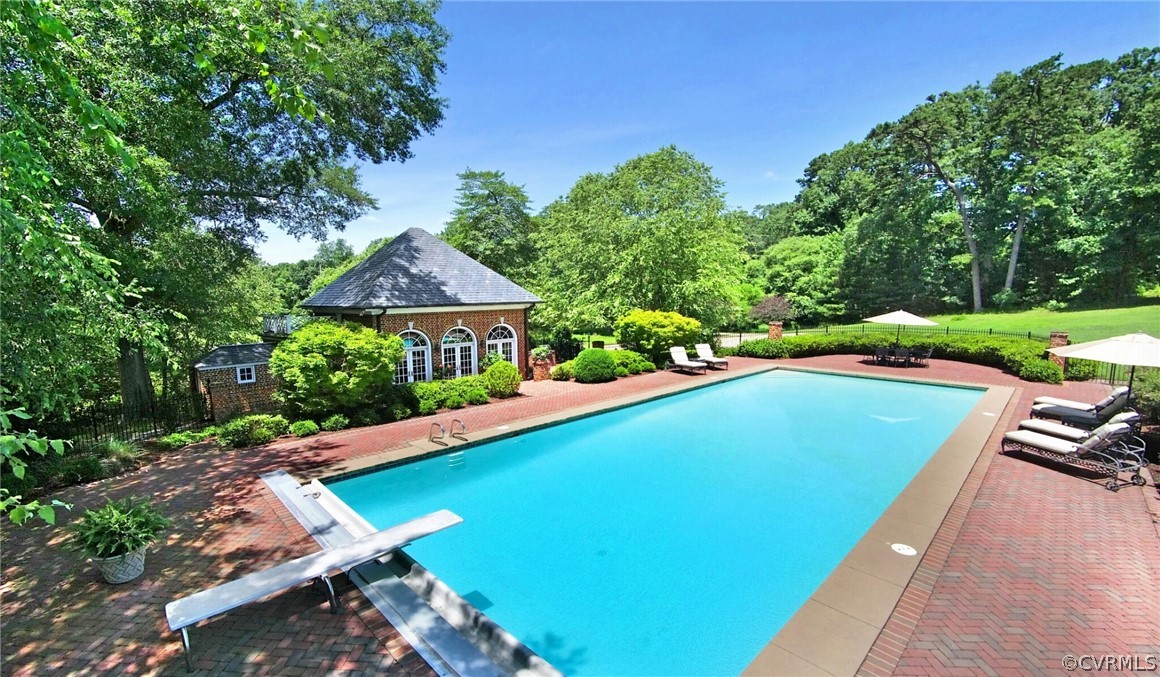 8899 River Road Henrico, VA 23229 - Photo 36 of 50 a view of a swimming pool and lounge chairs
