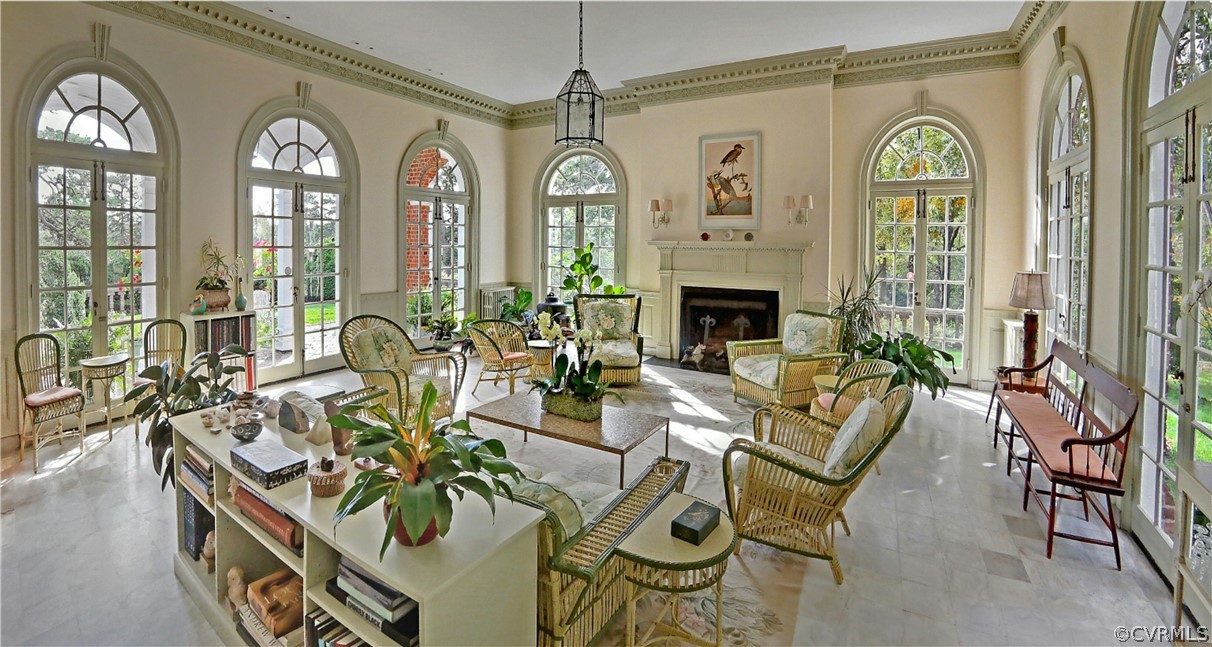 8899 River Road Henrico, VA 23229 - Photo 10 of 50 a living room with furniture a fireplace and a chandelier
